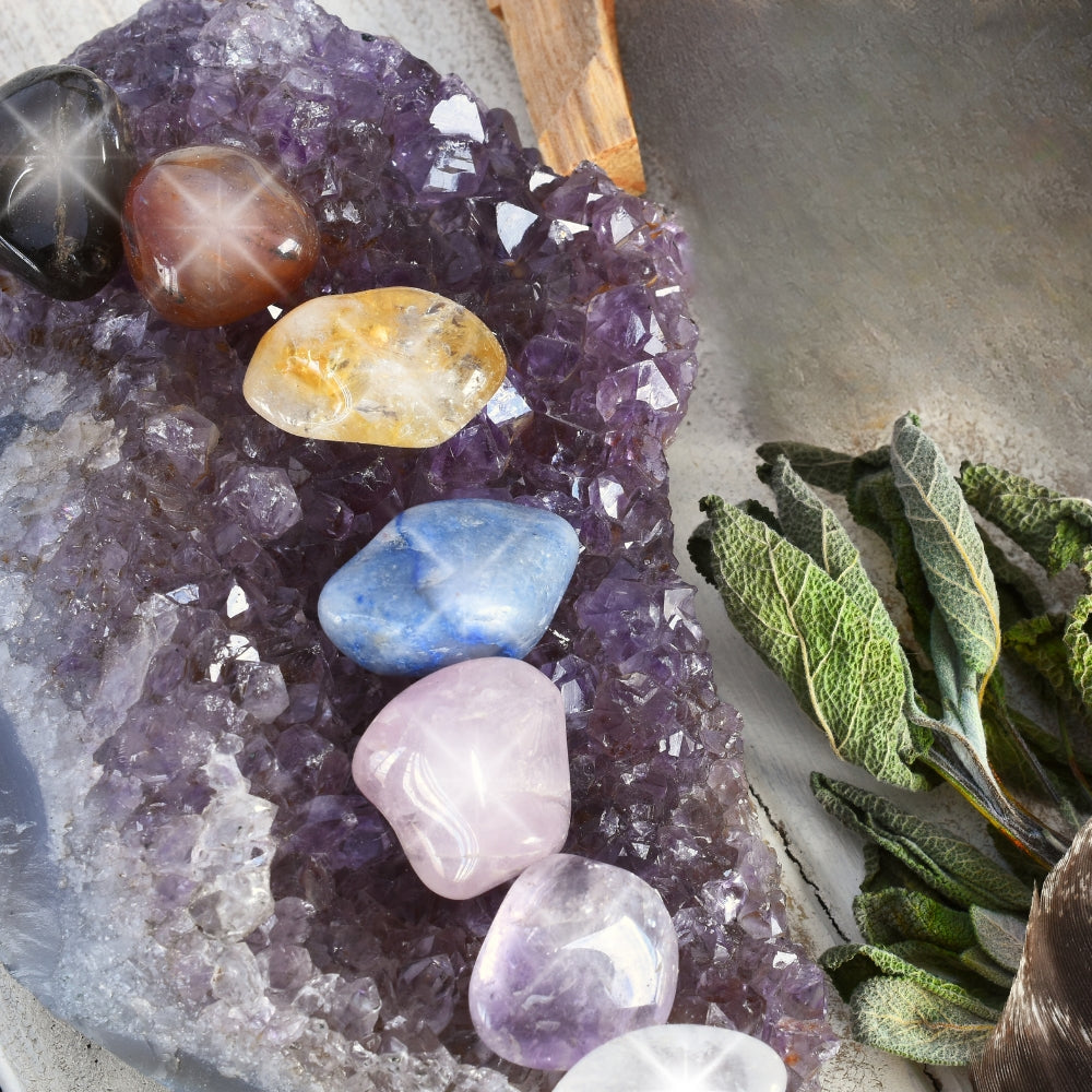 amethyst with chakra stones and dried herbs